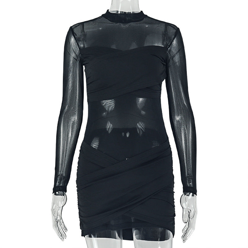 Black wrap pleated dress on mannequin, mock neck, sheer sleeves, layered ruched wrap