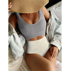 One-piece swimsuit with gray scoop top and speckled bikini briefs, seamless fit
