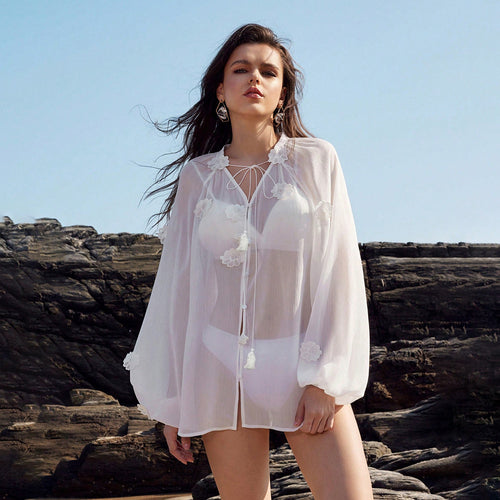 White sheer cover-up tunic with long sleeves, tassel neckline and floral patches