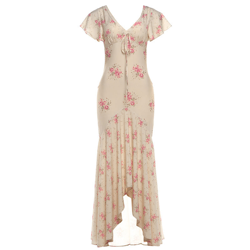 Light pink floral maxi dress with V-neck and short flutter sleeves, gathered waist, slit hem
