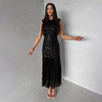 Black sleeveless maxi sequin dress with glitter bodice and flowy pleated hem