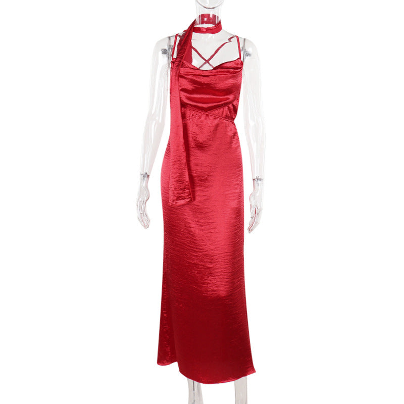 Red satin slip dress on mannequin, cowl neckline and cross-back straps