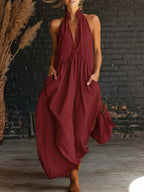 Burgundy sleeveless halter maxi dress with deep V neckline and gathered waist