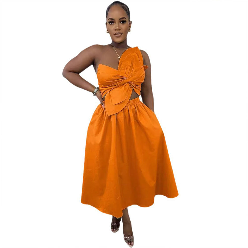 Orange sleeveless midi dress with front knot detail and flowing gathered skirt