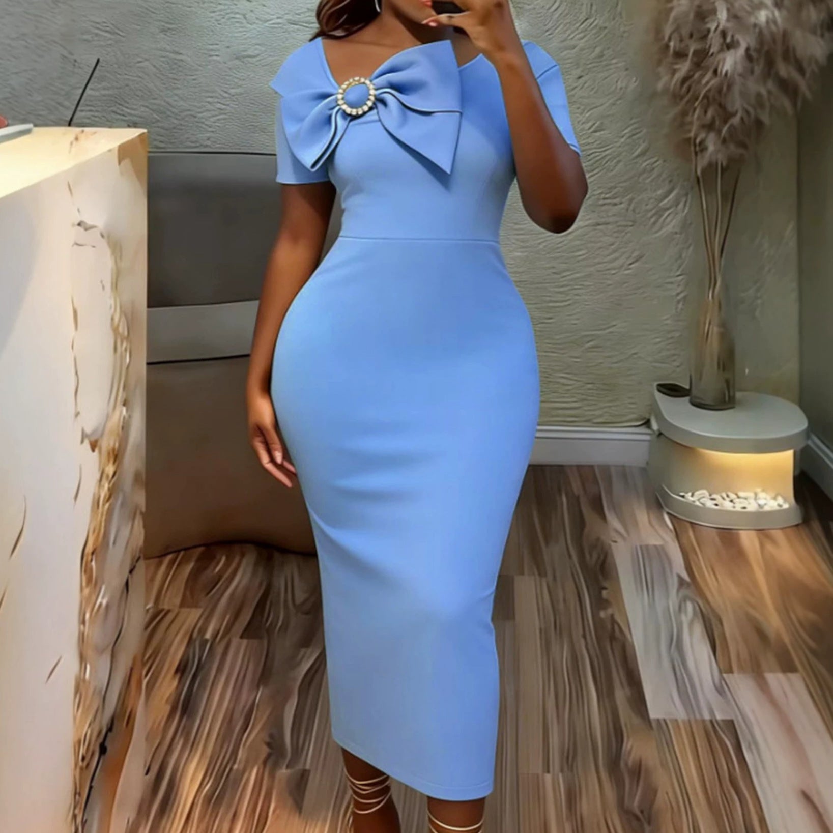 Sky blue fitted midi dress with round neck, short sleeves, and bow detail at chest