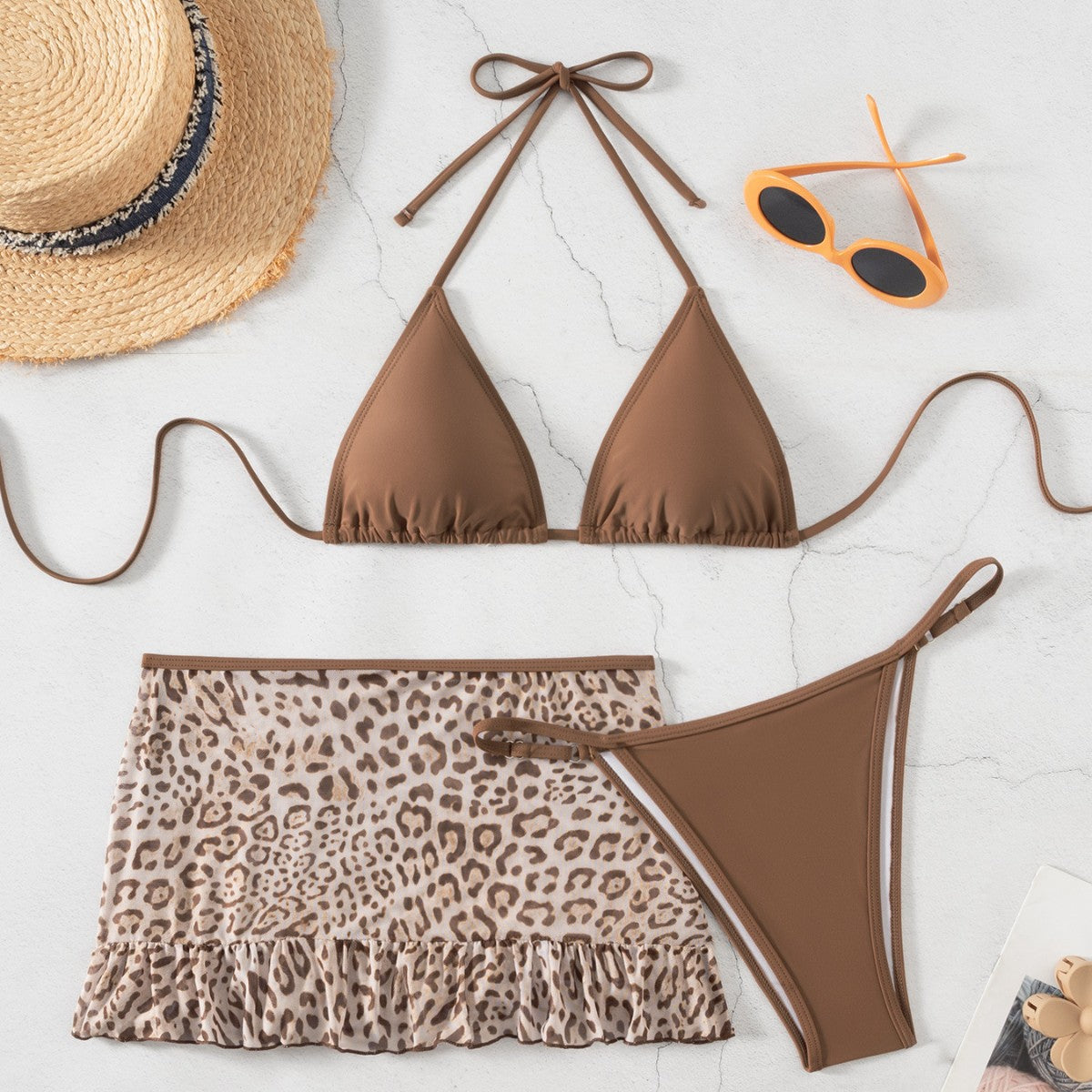 Brown halter swimwear with triangle top, leopard ruffle skirt, and matching bikini bottom