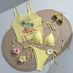Yellow tropical one-piece swimsuit with palm fruit graphic and tie side accents