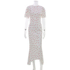 White maxi polka dot dress with short sleeves, straight fitted hem, front slit