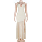 Women's cream sling spring dress on mannequin, spaghetti straps and tiered maxi hem