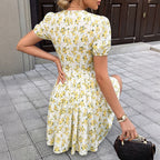Yellow floral V-neck dress with puff sleeves, ruched waist, and mid-length skirt