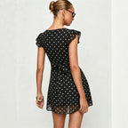 Black polka dot mini dress, back bow tie detail, short ruffle sleeves