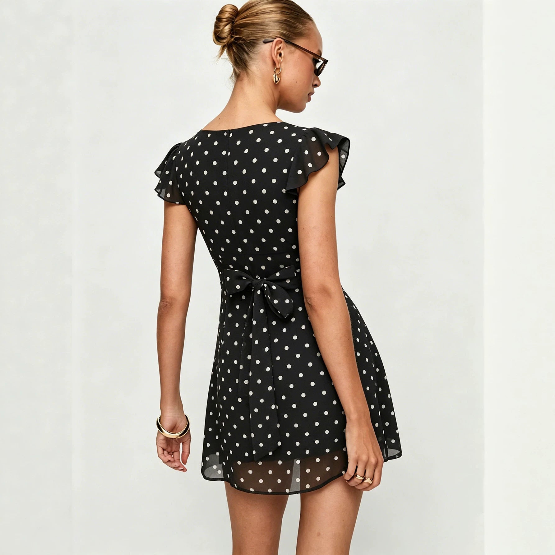 Black polka dot mini dress, back bow tie detail, short ruffle sleeves