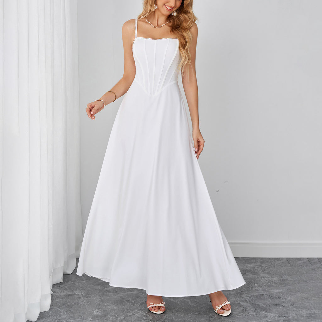 White sleeveless maxi dress with sweetheart neckline and ruched bodice.
