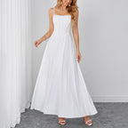 White sleeveless maxi dress with sweetheart neckline and ruched bodice.