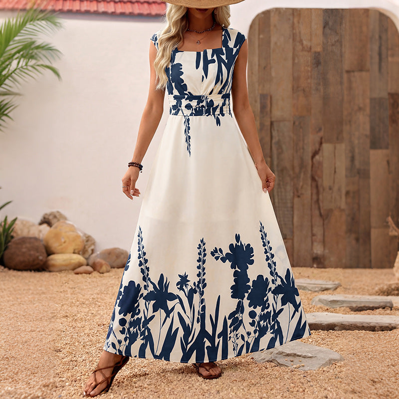 Sleeveless maxi dress in white with blue floral print, gathered waist and A-line skirt