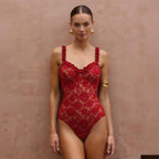 Red lace one-piece swimwear on model with bow-front bust and thin scalloped straps