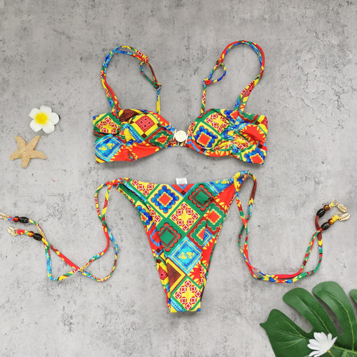 Bandeau cover-up bikini set, colorful patterned top, matching tie-side bottoms laid flat
