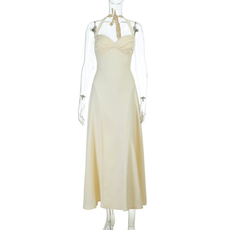 Pleated slip dress on mannequin, pale yellow V-neck with thin straps and flowing skirt