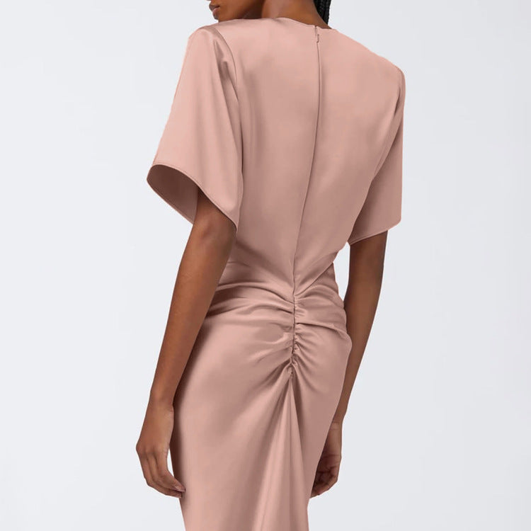 Pink satin sheath dress, back view with short sleeves and ruched back waist knot