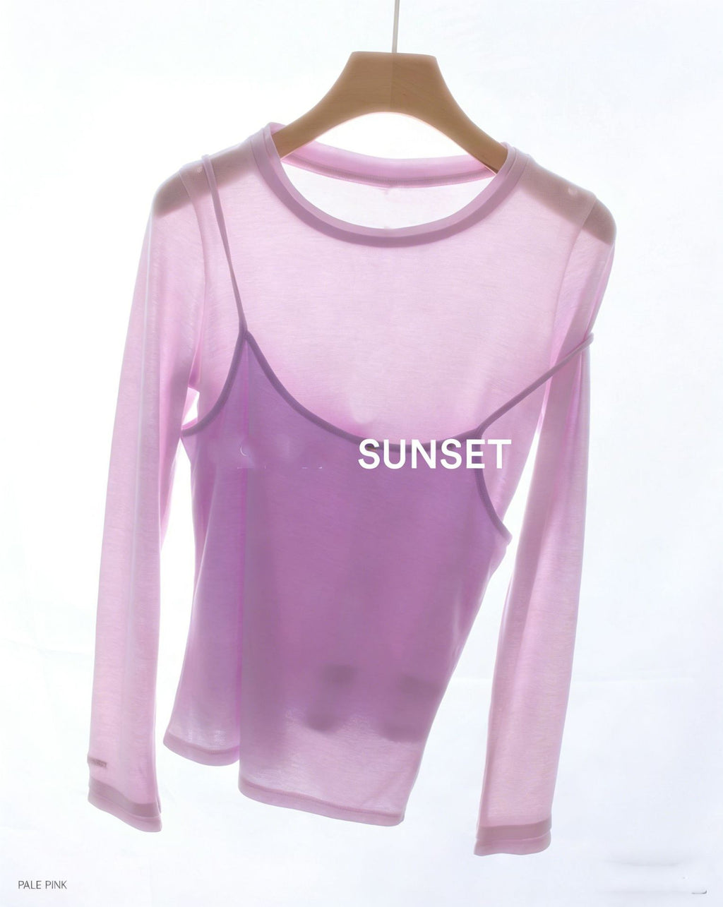 Pink long-sleeve top with faux camisole overlay and “SUNSET” print