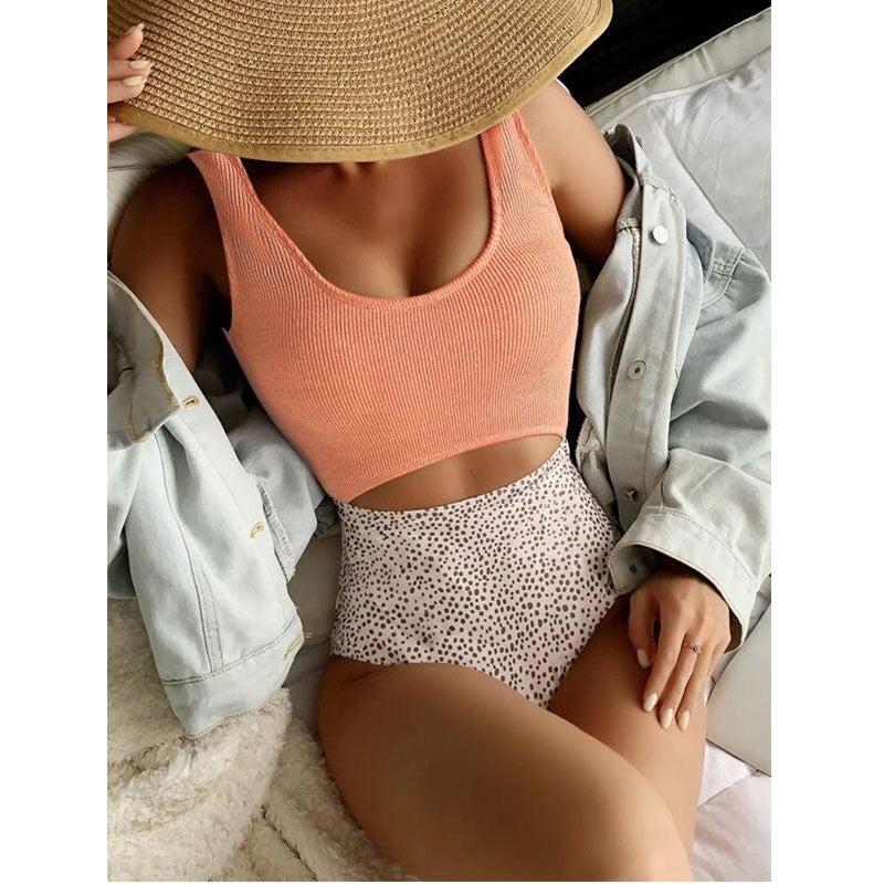 One-piece swimsuit with coral scoop top and speckled bikini briefs, seamless fit