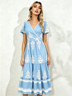 Light blue midi short-sleeve dress with V-neck and white floral embroidery, tiered skirt