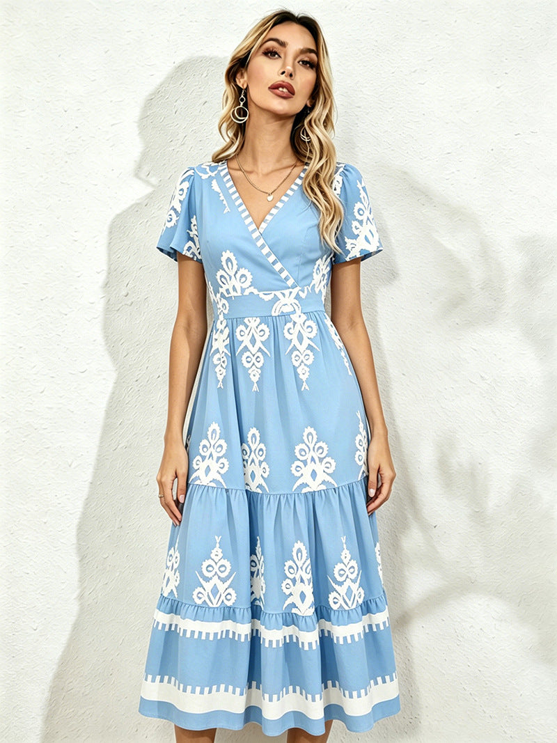Light blue midi short-sleeve dress with V-neck and white floral embroidery, tiered skirt