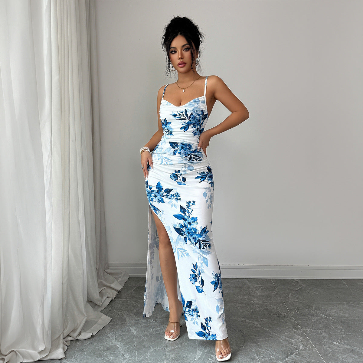 Maxi sling dress with white and blue floral print, spaghetti straps, ruched waist