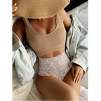 One-piece swimsuit with beige scoop top and speckled bikini briefs, seamless fit