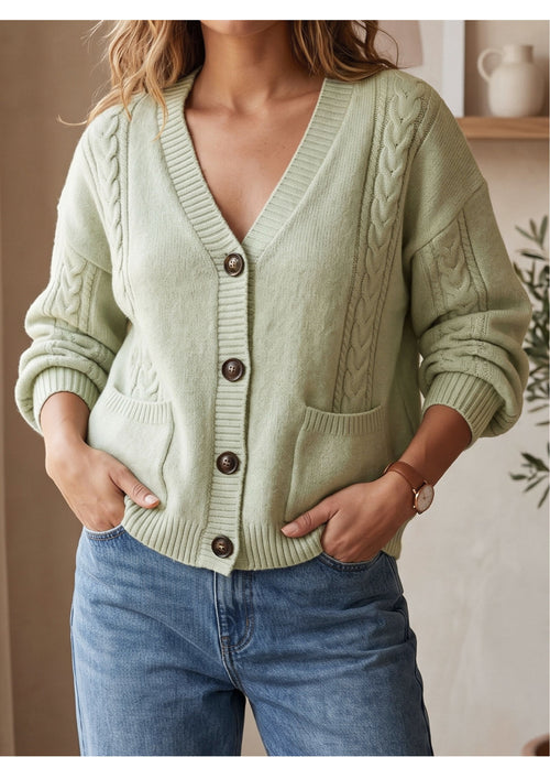 Light green cable-knit V-neck cardigan with long sleeves, button front and patch pockets