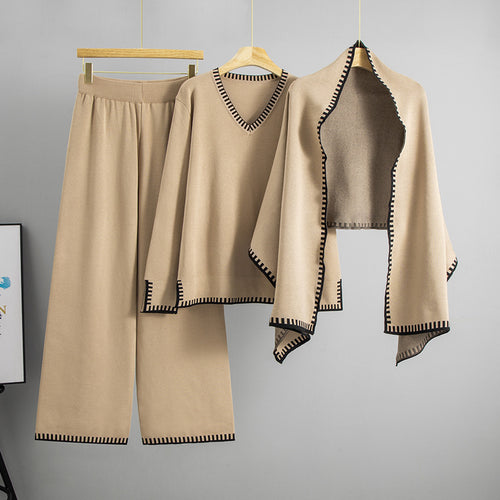 Women's khaki knitted three-piece set with V-neck sweater, shawl-style layer, and wide-leg pants.