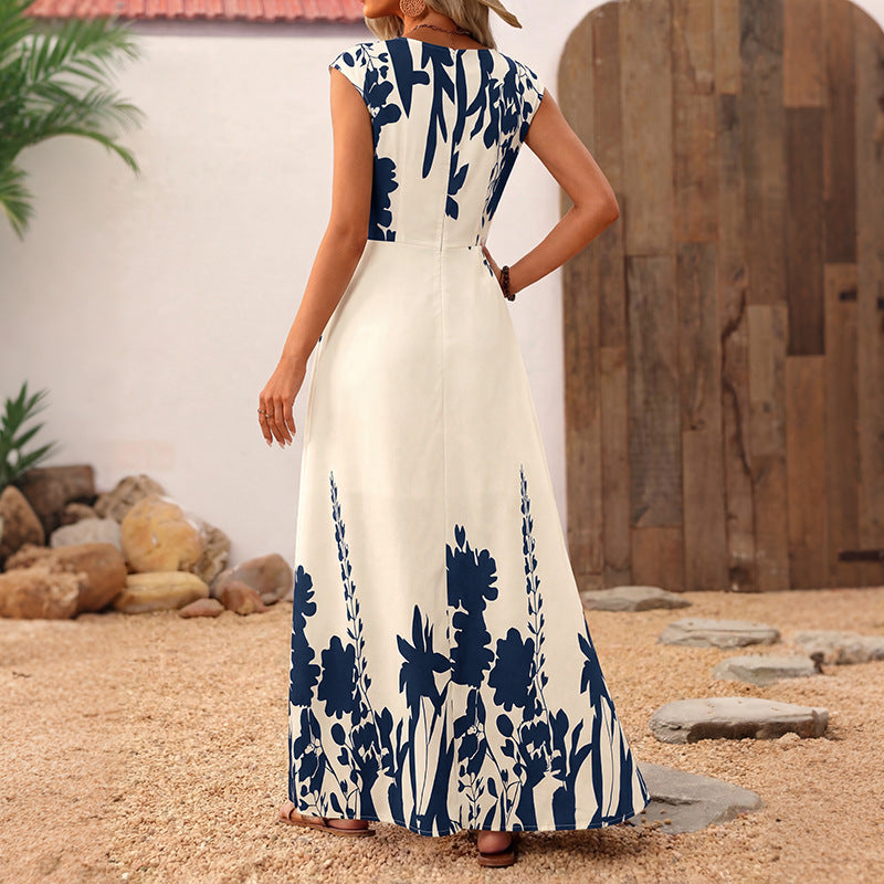 Sleeveless maxi dress, back view: blue floral print on white with elastic waist gathers