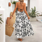 Back view of black-and-white halter maxi dress with open tie-back