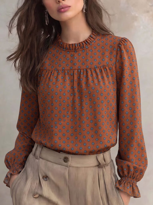 Printed ruffle-collar blouse with gathered yoke and long bell sleeves, rust-brown pattern