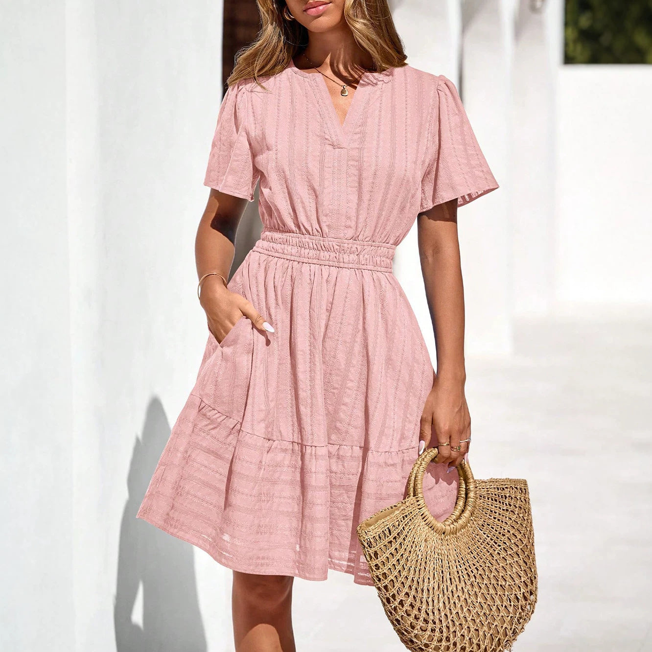 Pink short-sleeve summer dress with V-neck and tiered skirt