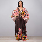 One-piece beach dress in dark brown with bold pink and orange floral print