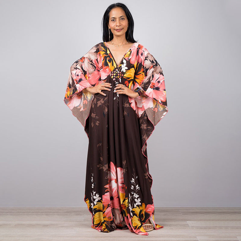 One-piece beach dress in dark brown with bold pink and orange floral print
