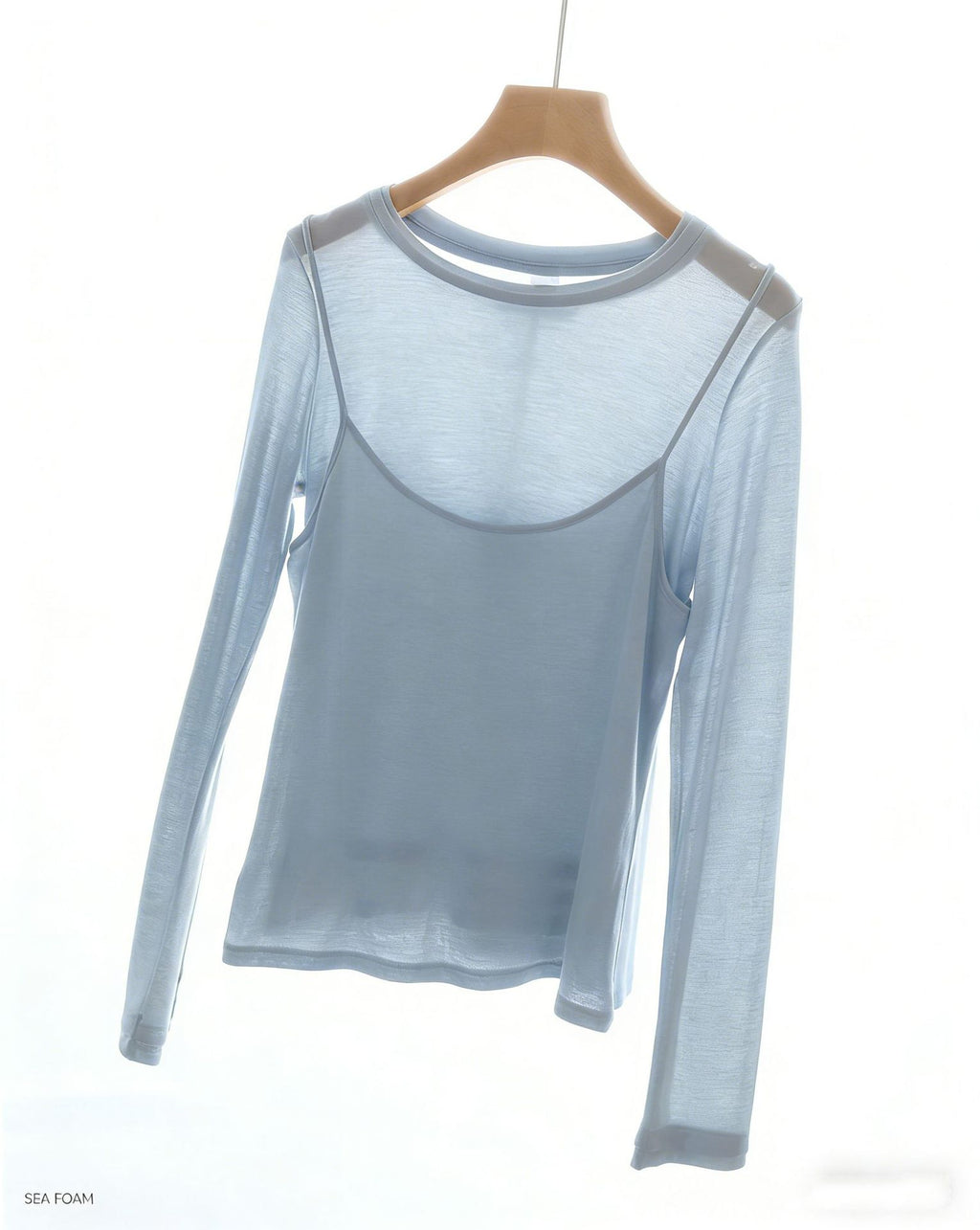 Light blue long-sleeve top with faux camisole overlay, sheer-looking sleeves