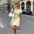 Women's lace-trim pleated dress in pale yellow, short sleeves and buttoned bodice