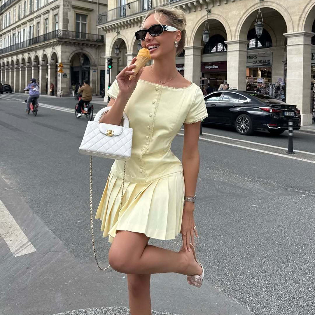 Women's lace-trim pleated dress in pale yellow, short sleeves and buttoned bodice