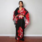 One-piece beach swim dress with V-neck and draped sleeves, black with red flower print