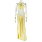 Pale yellow lace halter dress on mannequin with bow at bust, draped waist, long skirt