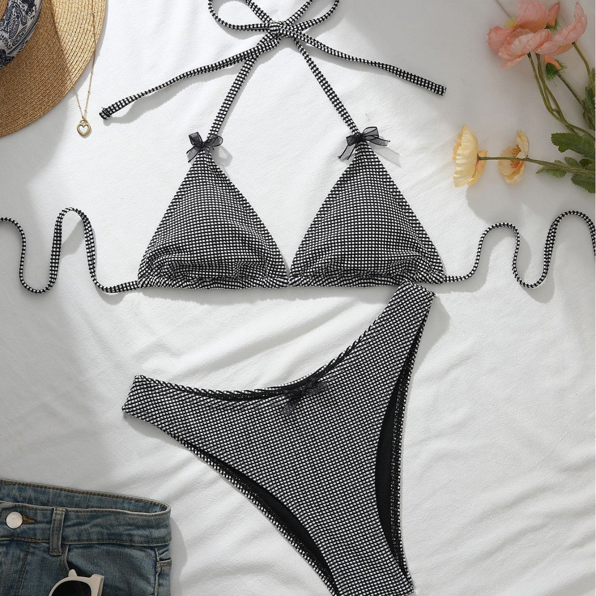 Black-and-white check bikini with bow halter triangle top and matching high-cut bottoms