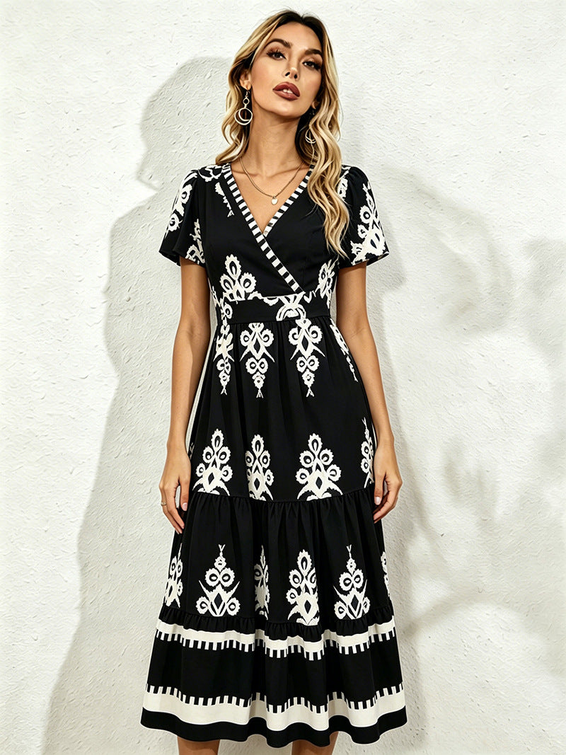 Black midi short-sleeve dress with V-neck and white floral embroidery, tiered skirt