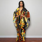 One-piece beach swim dress with V-neck and draped sleeves, yellow-orange floral stripe print