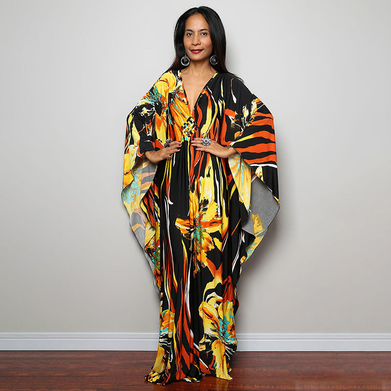 One-piece beach swim dress with V-neck and draped sleeves, yellow-orange floral stripe print