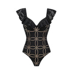 Black one-piece swimsuit with ruffled high neckline, studded gold dot pattern