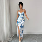 Maxi slip dress with spaghetti straps and blue floral print on white, front side slit