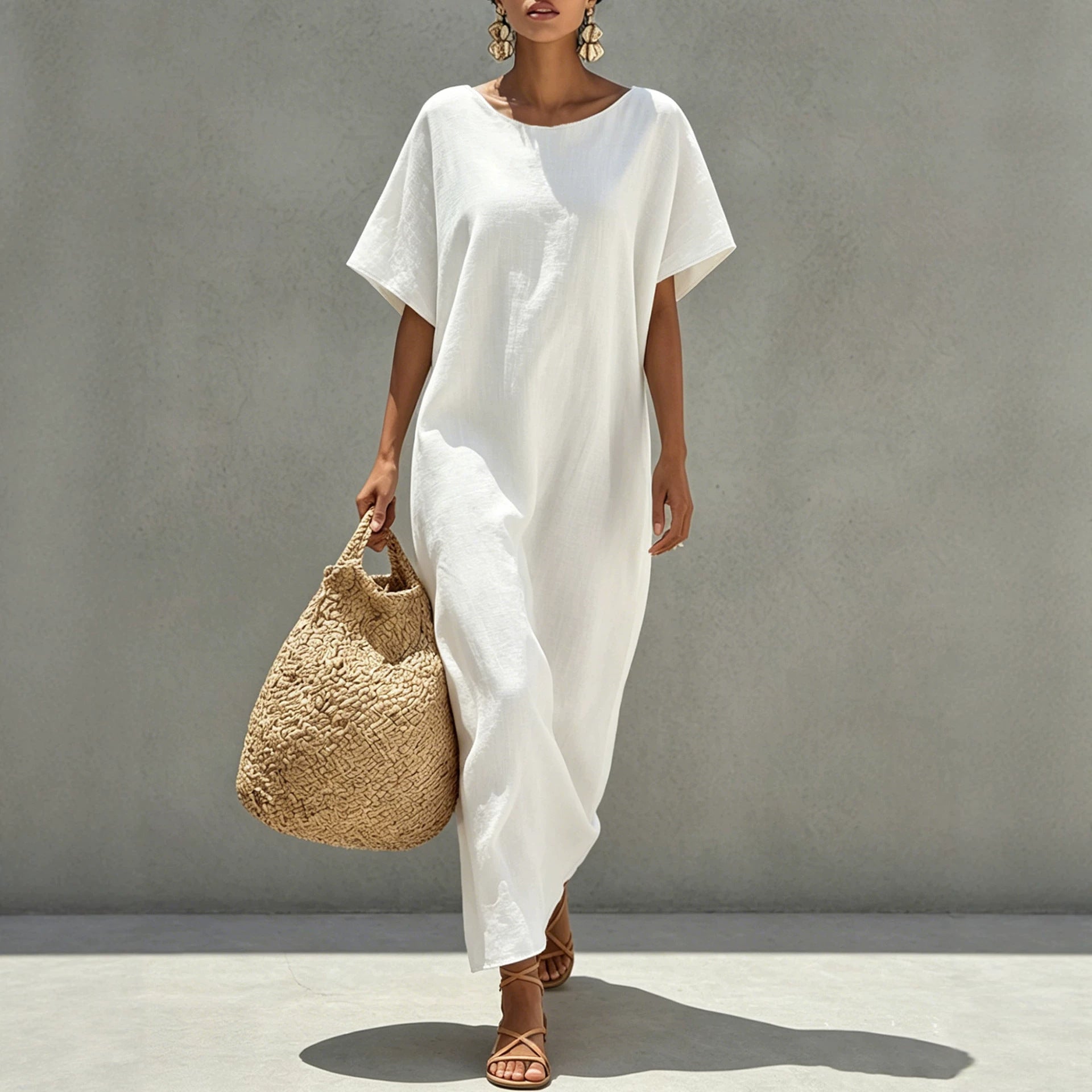 White short-sleeve shift dress with round neckline, relaxed fit and uneven drape hem