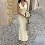 Cream sleeveless halter maxi dress with fitted bodice and V-neck front